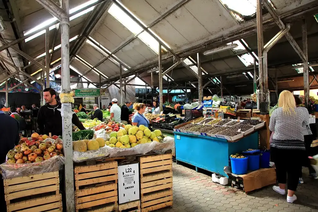 Marché local en Albanie avec étals de fruits frais, légumes et fromages